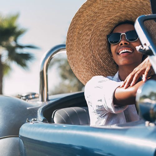 black-woman-driving-a-vintage-convertible-car-BFYH7K3.jpg